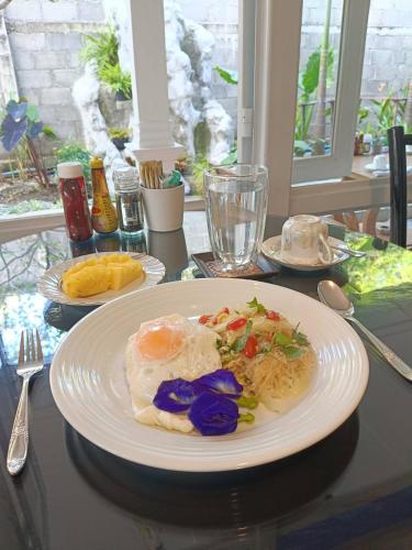 a plate of eggs and vegetables on a table at Baan Debtida in Bangkok
