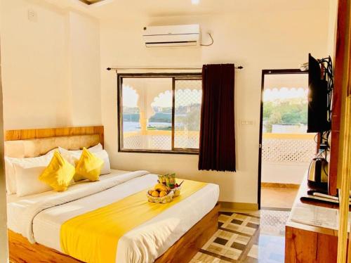 a bedroom with a bed with a bowl of fruit on it at Vallabhgarh A lake facing balcony in Udaipur