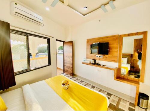 a bedroom with a large bed and a tv at Vallabhgarh A lake facing balcony in Udaipur