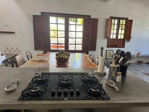 a kitchen with a stove top oven in a kitchen at Casa Amor With Sea View in Goiana