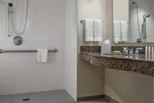 a hotel bathroom with a sink and a shower at Le Meridien Dallas by the Galleria in Dallas