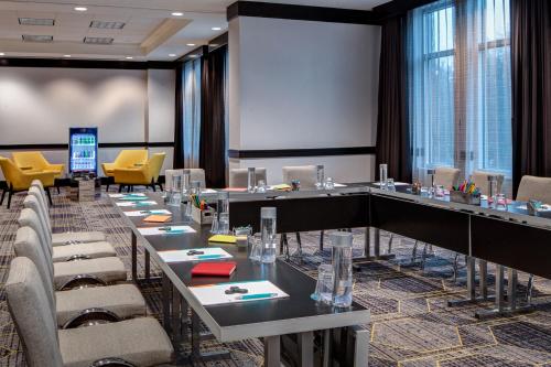 a conference room with long tables and chairs at Le Meridien Dallas by the Galleria in Dallas