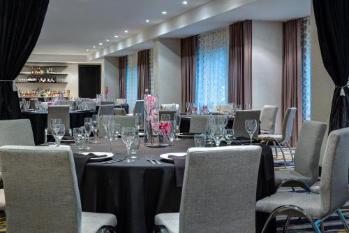 a conference room with tables and chairs with wine glasses at Le Meridien Dallas by the Galleria in Dallas