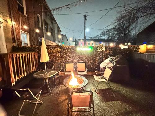 a patio with chairs and a table with a fire in it at Downtown Loft - Close to Topgolf, Horseshoe Casino, UM Baltimore in Baltimore