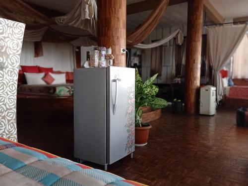 a refrigerator standing in a room with a living room at Rara Villas Lombok in Senggigi 