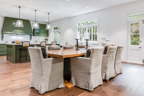 a kitchen and dining room with a wooden table and chairs at Villa Northcote Luxurious 4BR Wood Fireplace Leura in Leura