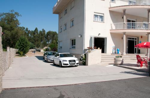 a white car parked in front of a building at Hotel Ria Toxa in Revolta
