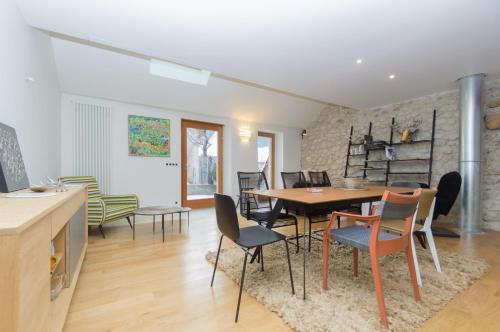 a dining room with a table and chairs at Le Petit Chalande in Autrans