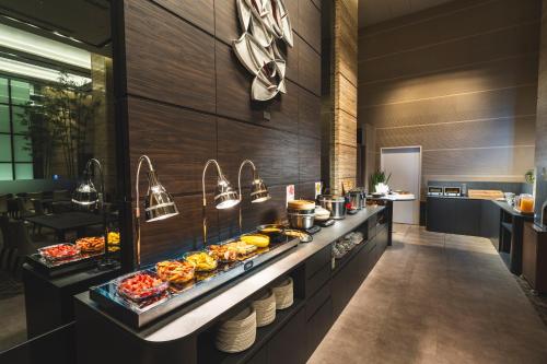 a buffet line with food on it in a restaurant at KOKO HOTEL Premier Kanazawa Korinbo in Kanazawa