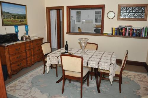 a room with a table, chairs, and a table cloth at Apartments on Fiedler in Tanunda