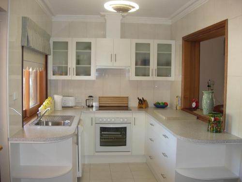 
a kitchen with a sink, stove, microwave and dishwasher at Apartments on Fiedler in Tanunda
