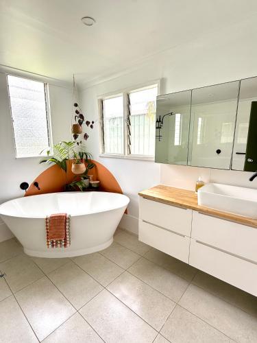 a bathroom with a large tub and two sinks at Blackwood River Art Studio in Augusta