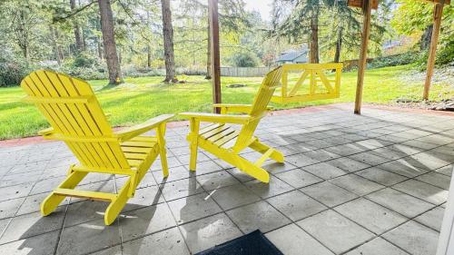 two yellow chairs sitting next to each other on a patio at Family friendly house with MIL suite in Sammamish