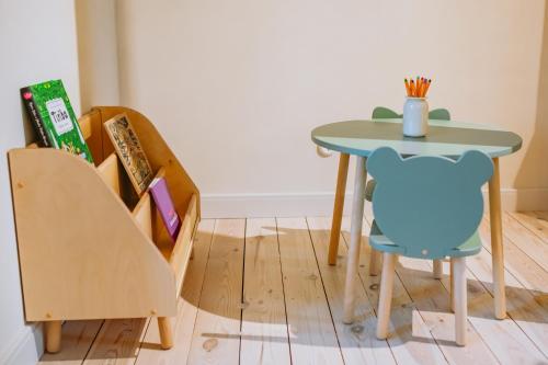 a table and chairs and a table and a chair at Saieta 2 Apartments in Madona