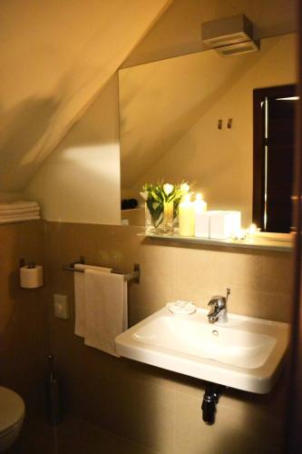a bathroom with a sink and a mirror at Penzion Luxor in Trnava