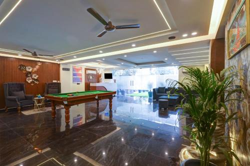 a room with a pool table in the middle of it at Royal Residency - Medanta in Gurgaon