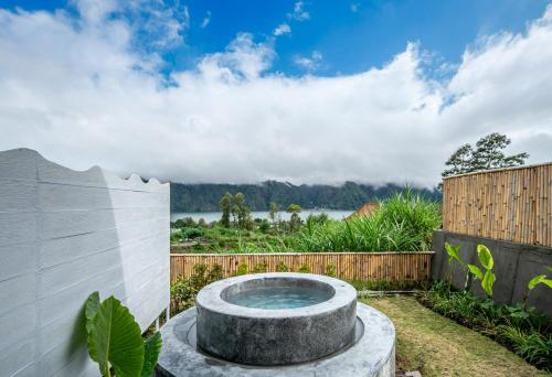 a garden with a bird bath in the yard at The Dewi Kintamani Luxury Glamping and Natural Hotspring in Kintamani