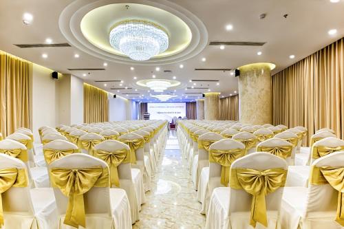 a row of chairs in a banquet hall with a chandelier at Avatar Danang Hotel in Da Nang