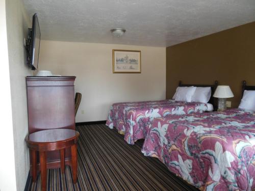 a hotel room with two beds and a table at Route 66 Inn in Amarillo