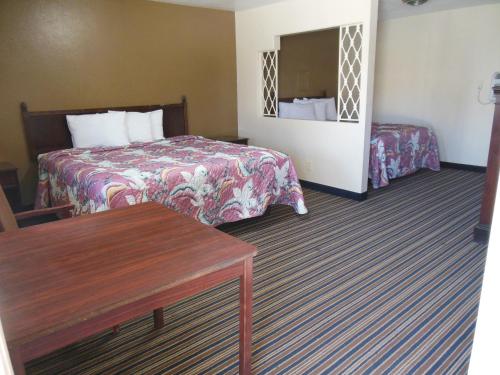a hotel room with two beds and a table at Route 66 Inn in Amarillo