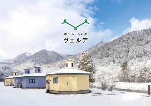 a poster of a building in the snow with an arrow at Hotel Furano Verde in Furano