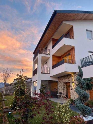 aominium building with a sunset in the background at Maso Valèr - Agritur in Tassullo