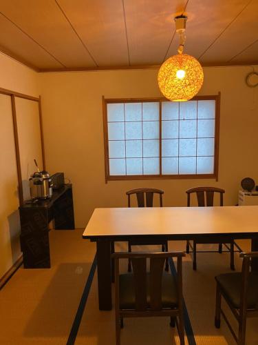 a dining room with a table and chairs at TrainLineField in Tōbetsu