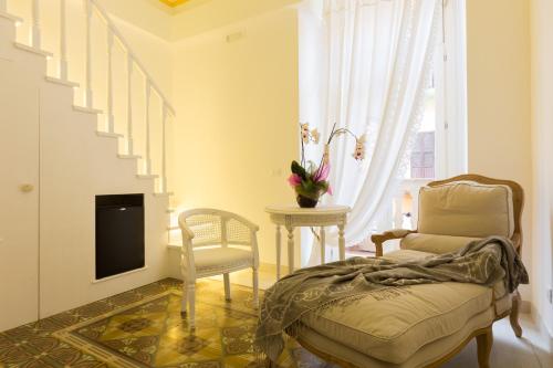 
a living room with a couch, chair and a tv at Suite Le Perle in Taranto
