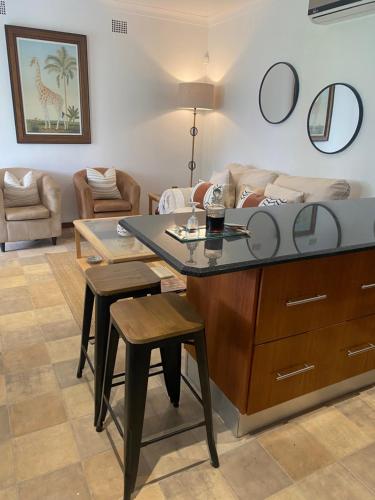 a living room with a table and chairs and a couch at Silver Linings Cottage in Parys