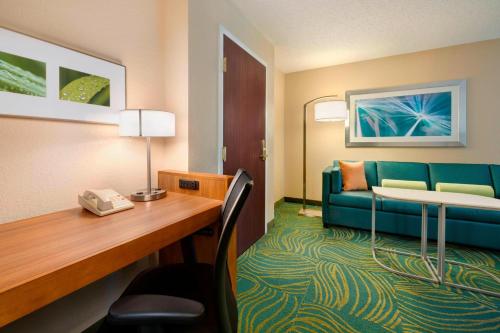 a hotel room with a desk and a couch at SpringHill Suites Mishawaka-University Area in South Bend