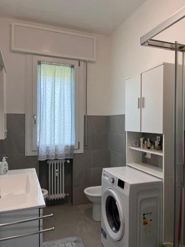 a bathroom with a washing machine and a sink at A 3 passi da tutto in Treviso