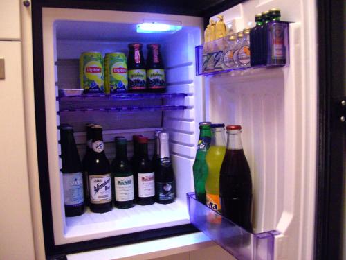 an open refrigerator filled with lots of bottles of alcohol at Frühstückspension Leopold Janu in Senftenberg