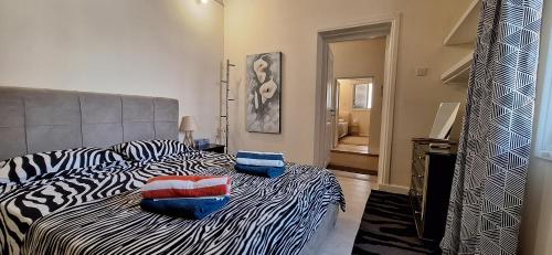 a bedroom with a bed with pillows on it at Lydia's Sea View - 2 bed House in Episkopi Lemesou