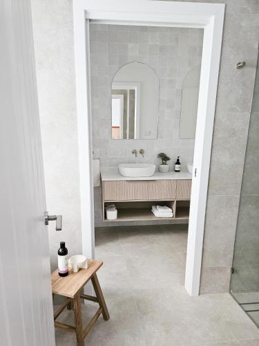 a bathroom with a sink and a mirror at Olas Villa 6 - Plunge Pool & Walk to Beach in Anna Bay