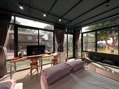 a living room with a bed and a desk at Mei Nong Villa in Meinong