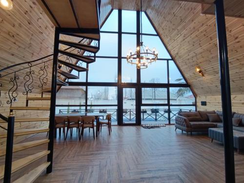 a large room with a staircase and a living room at A Frame Houses in Sheki