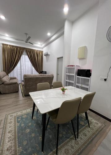 a living room with a white table and chairs at Homely Stay by MySky Stays at Presint 5, Putrajaya in Putrajaya