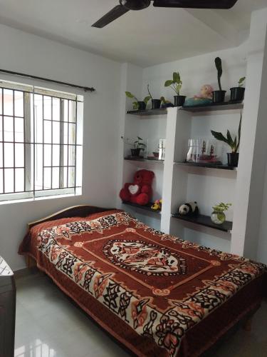 a bedroom with a bed in a room with shelves at KINGS TOWN - Serene Bliss County in Coimbatore