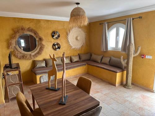 a living room with a couch and a table at The Mogador's Oasis in Akermoud