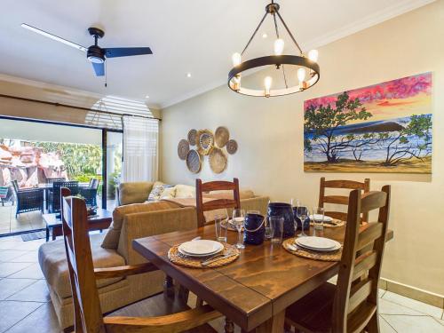 a dining room and living room with a table and chairs at Sunrise 1- 3 Bedroom Poolside Condo in Tamarindo