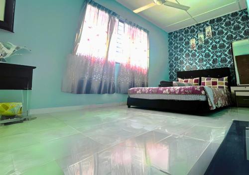 a bedroom with a bed and a large window at COZY Home Terrace - 1km to Water Theme Park Tambun Ipoh in Ipoh