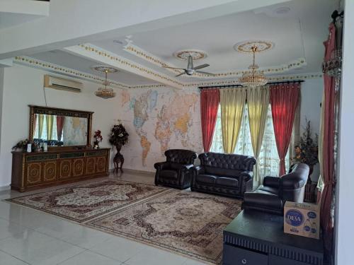 a living room with two chairs and a map on the wall at VILLA SHAMIR in Sepang