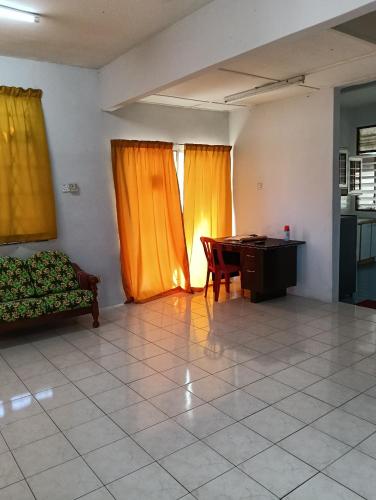a living room with a couch and a table at Homestay Jannati Bandar Baru Putra Ipoh in Ipoh