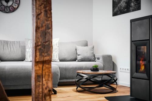 a living room with a couch and a coffee table at Landhotel Voss im TalVital in Saalhausen