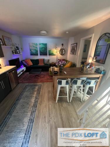 a living room with a table and a couch at Private NE Portland Guesthouse in Portland
