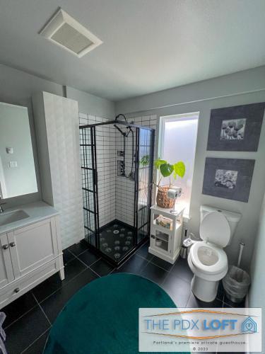a bathroom with a toilet and a sink and a shower at Private NE Portland Guesthouse in Portland