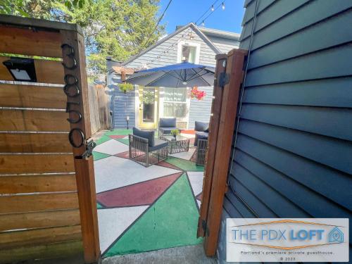 an open door to a patio with an umbrella at Private NE Portland Guesthouse in Portland