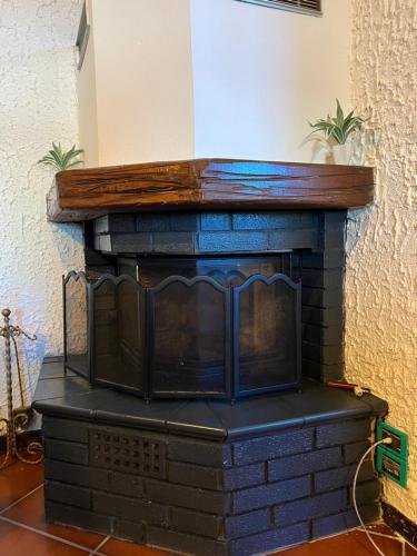 a brick fireplace with a wooden top at Panorama in Someraro