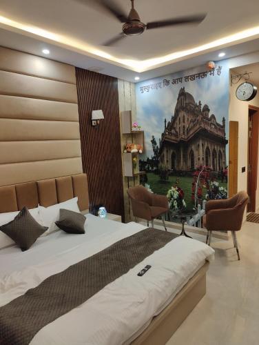 a bedroom with a large bed and a painting on the wall at Nestle Luxury Homes 1 in Lucknow