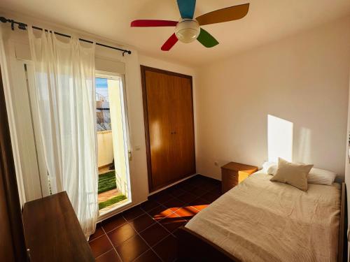 a bedroom with a bed and a ceiling fan at Casa en la Playa Alcossebre La Creueta in Alcossebre